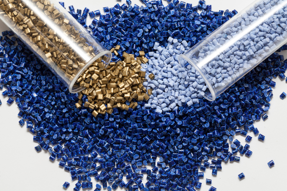 plastic granules, blue and gold close up